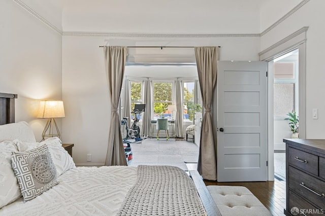 bedroom featuring access to exterior and dark hardwood / wood-style flooring