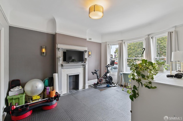 workout room with a brick fireplace