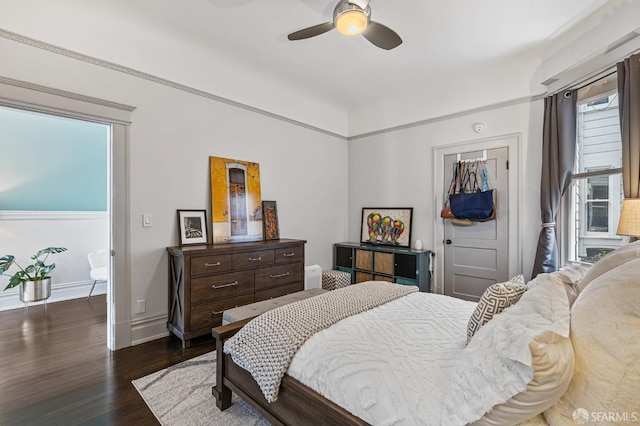 bedroom with ceiling fan, dark hardwood / wood-style floors, and multiple windows