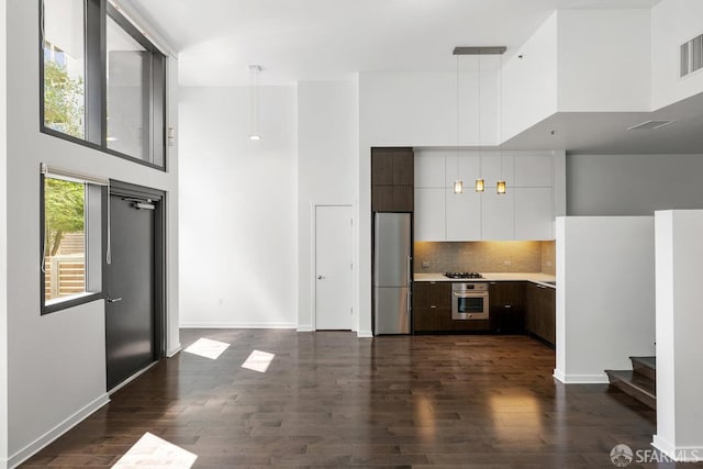 1788 Clay St Unit 103, San Francisco, CA 94109 - kitchen featuring stainless steel oven, a high ceiling, light countertops, white cabinetry, and modern cabinets