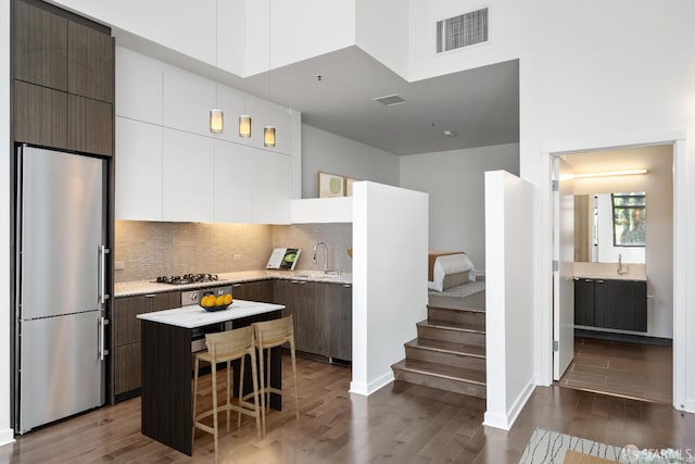 1788 Clay St Unit 103, San Francisco, CA 94109 - kitchen with stainless steel refrigerator, a sink, light countertops, gas stovetop, and dark wood finished floors