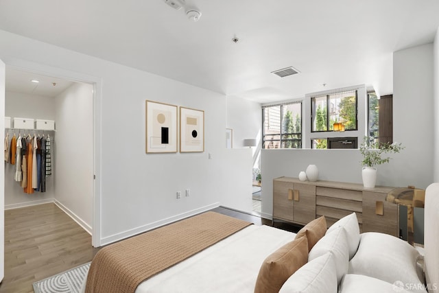 1788 Clay St Unit 103, San Francisco, CA 94109 - bedroom featuring wood finished floors, baseboards, a walk in closet, and a closet