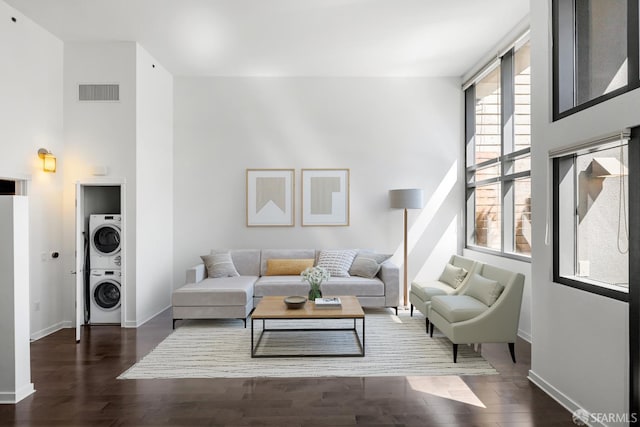 1788 Clay St Unit 103, San Francisco, CA 94109 - living area featuring stacked washer and clothes dryer, wood finished floors, baseboards, and a towering ceiling