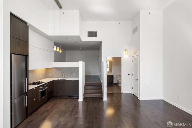 1788 Clay St Unit 103, San Francisco, CA 94109 - kitchen with stainless steel appliances, a sink, modern cabinets, a towering ceiling, and light countertops