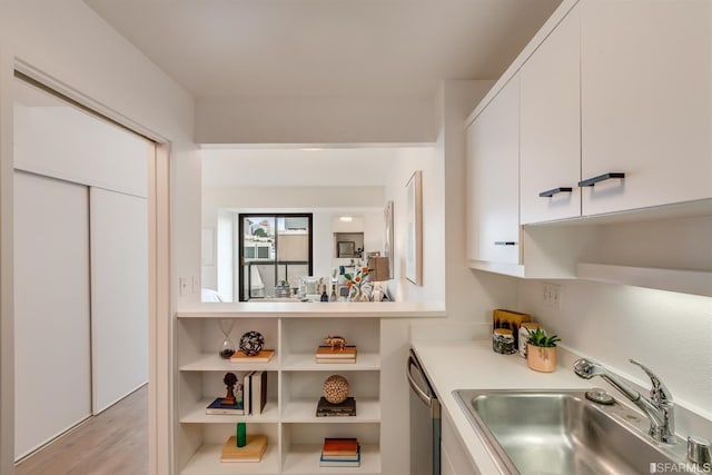 kitchen featuring sink, white cabinets, and dishwasher