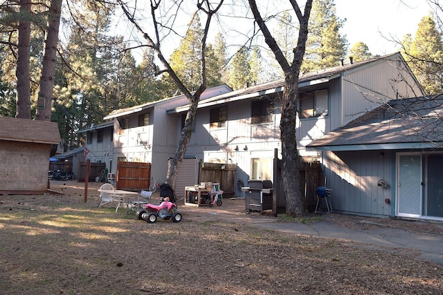 back of house with fence