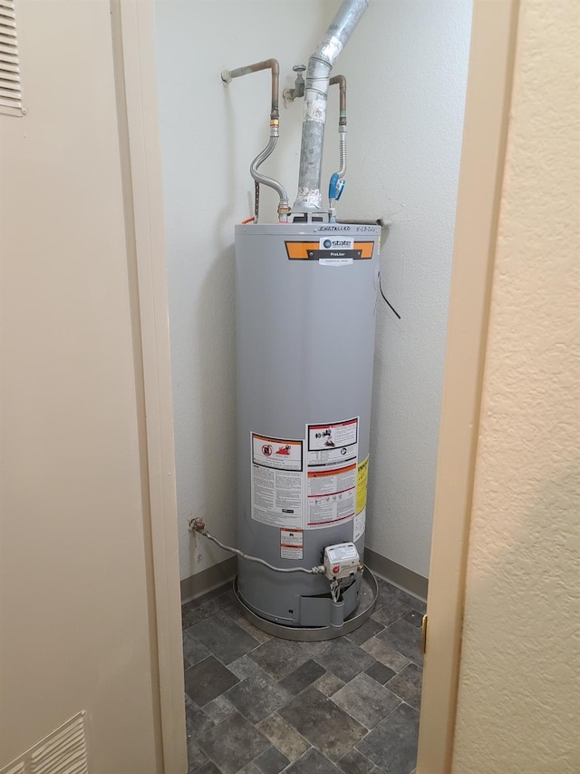 utility room featuring gas water heater