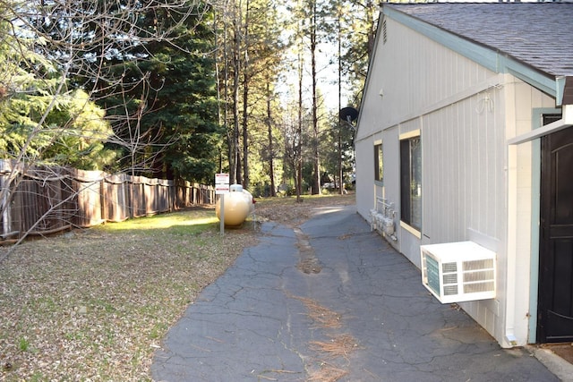 view of yard featuring a patio area, fence, and cooling unit