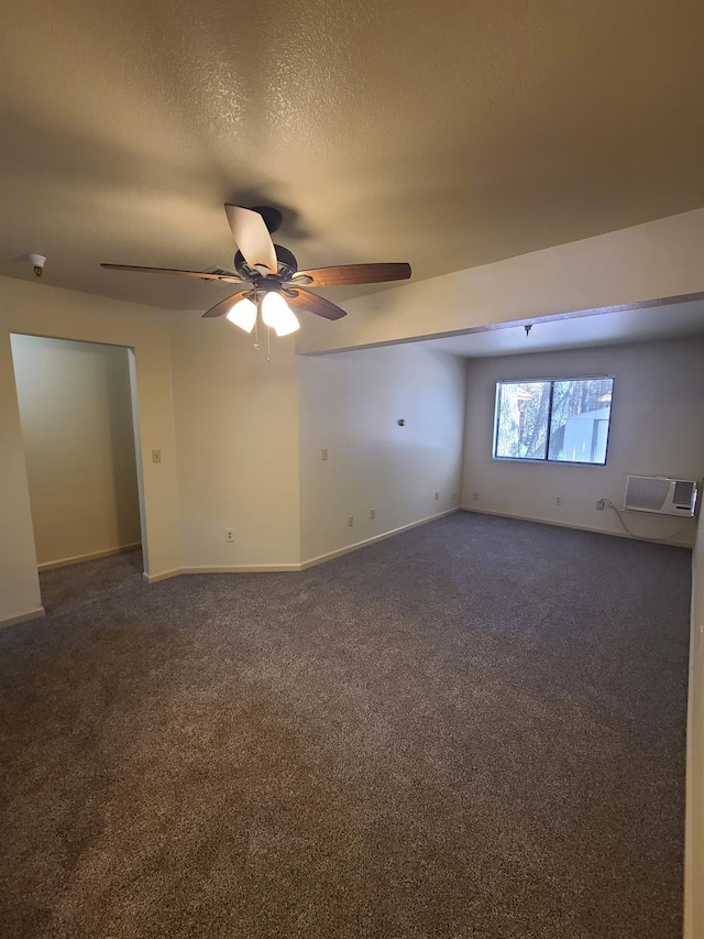 unfurnished room with baseboards, a ceiling fan, dark colored carpet, and a textured ceiling