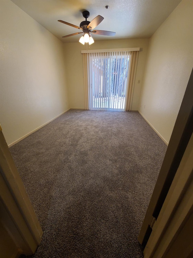 unfurnished room featuring carpet floors, ceiling fan, baseboards, and a textured ceiling