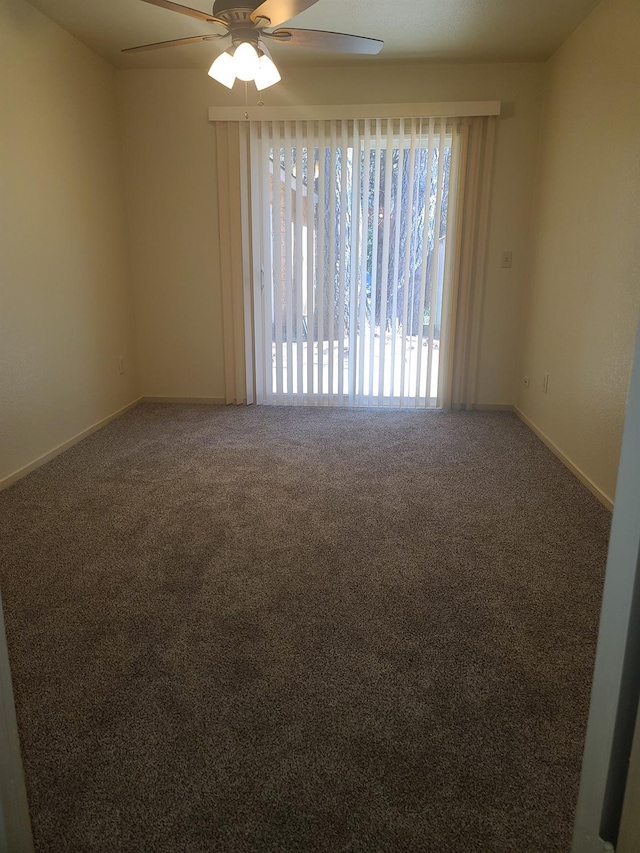 spare room with carpet floors, a ceiling fan, and baseboards