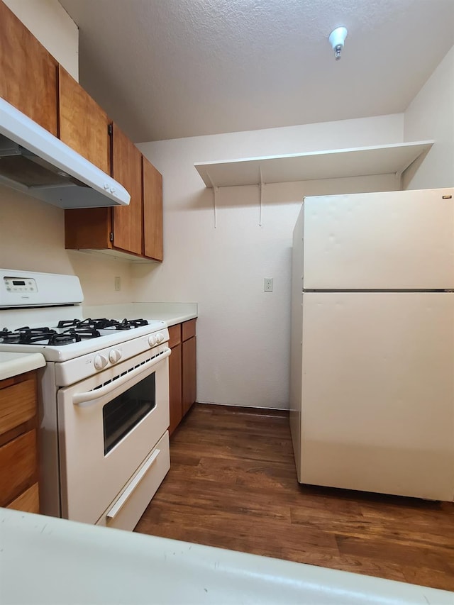 kitchen with brown cabinetry, white appliances, and light countertops