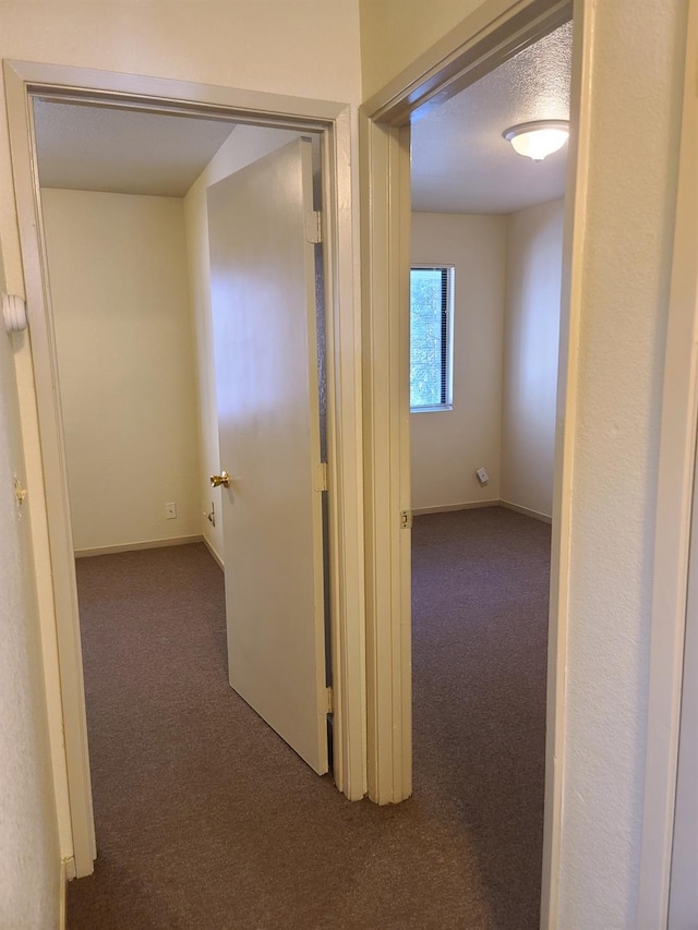 corridor featuring carpet and baseboards