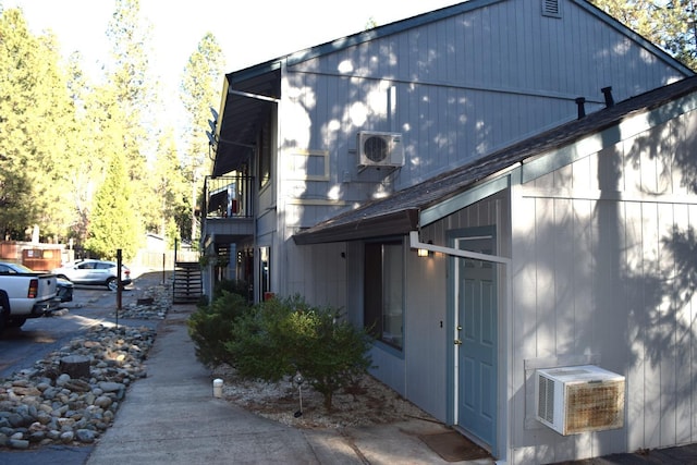 view of home's exterior featuring stairs and ac unit