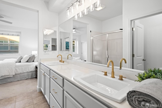 full bath with a sink, a shower stall, tile patterned floors, and double vanity