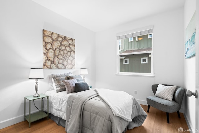 bedroom featuring baseboards and wood finished floors