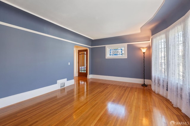 47 Brunswick St, San Francisco, CA 94112 - unfurnished room featuring arched walkways, baseboards, wood finished floors, and visible vents