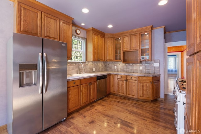 47 Brunswick St, San Francisco, CA 94112 - kitchen with tile countertops, brown cabinets, tasteful backsplash, a sink, and appliances with stainless steel finishes