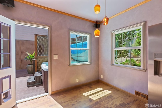 47 Brunswick St, San Francisco, CA 94112 - unfurnished dining area featuring crown molding, baseboards, wood finished floors, and visible vents