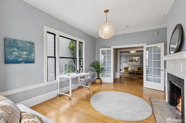 1250 Vallejo St Unit 1, San Francisco, CA 94109 - living area with ornamental molding, a desk, wood finished floors, and a warm lit fireplace