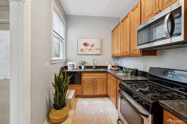 1250 Vallejo St Unit 1, San Francisco, CA 94109 - kitchen featuring appliances with stainless steel finishes, light tile patterned flooring, and brown cabinetry