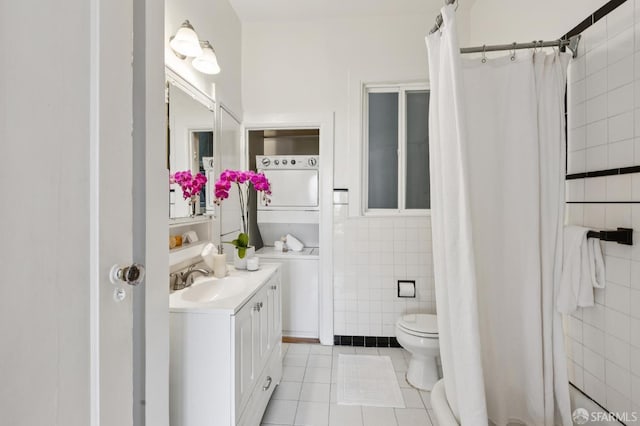 1250 Vallejo St Unit 1, San Francisco, CA 94109 - full bathroom with stacked washer / dryer, tile patterned floors, tile walls, vanity, and a shower with curtain