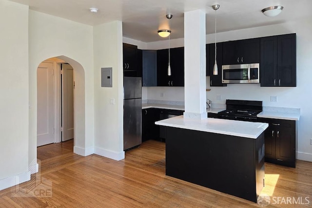 kitchen with dark cabinets and stainless steel appliances