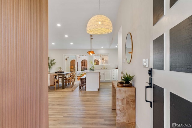 interior space featuring light hardwood / wood-style floors and a towering ceiling