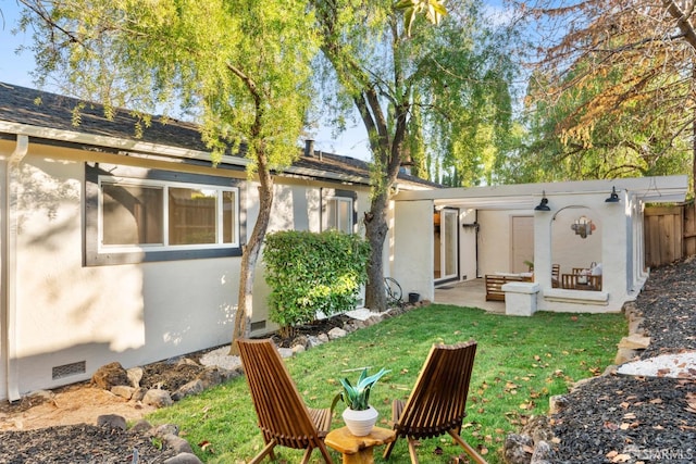 rear view of house featuring a patio and a lawn