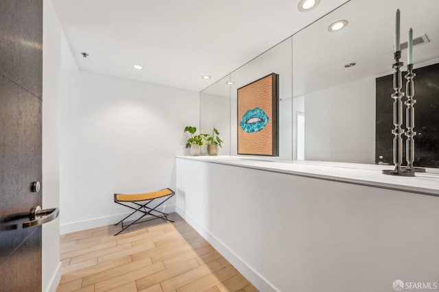 229 Brannan St Unit 11J, San Francisco, CA 94107 - hall with baseboards, wood finished floors, and recessed lighting
