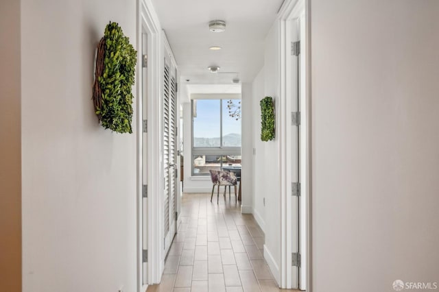 229 Brannan St Unit 11J, San Francisco, CA 94107 - corridor with light tile patterned flooring and baseboards