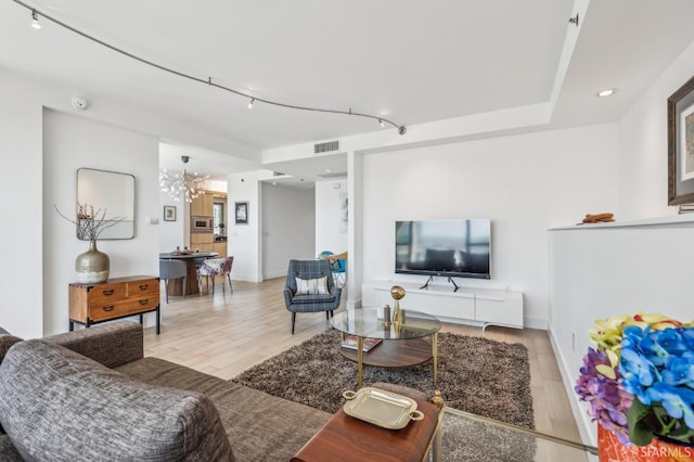 229 Brannan St Unit 11J, San Francisco, CA 94107 - living area featuring wood finished floors, rail lighting, recessed lighting, and baseboards