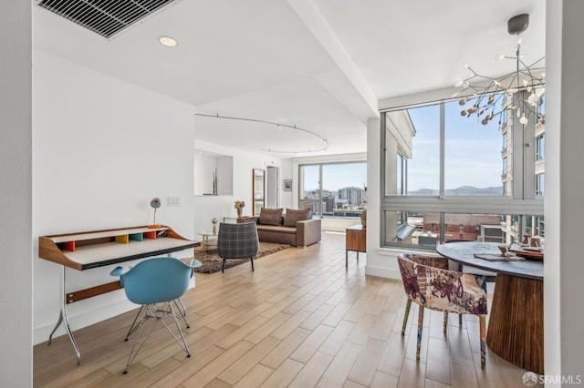 229 Brannan St Unit 11J, San Francisco, CA 94107 - dining area with wood finished floors, baseboards, a chandelier, and recessed lighting