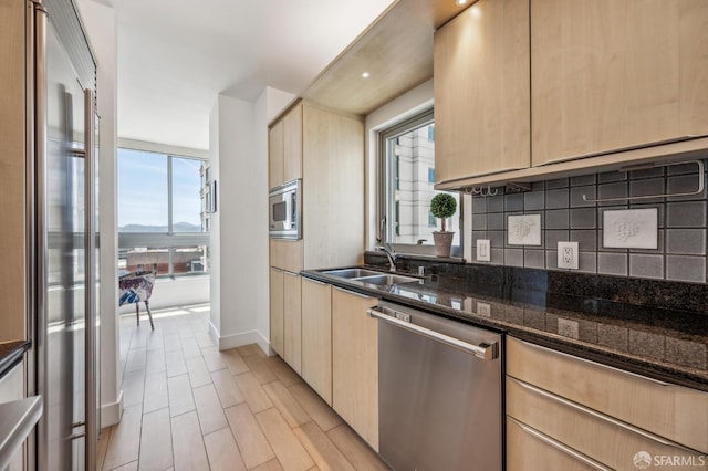 229 Brannan St Unit 11J, San Francisco, CA 94107 - kitchen with built in appliances, light brown cabinets, and a sink
