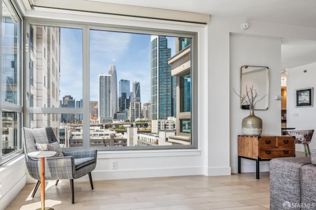 229 Brannan St Unit 11J, San Francisco, CA 94107 - sitting room with a view of skyline, wood finished floors, and baseboards