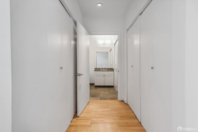 hall with light hardwood / wood-style floors