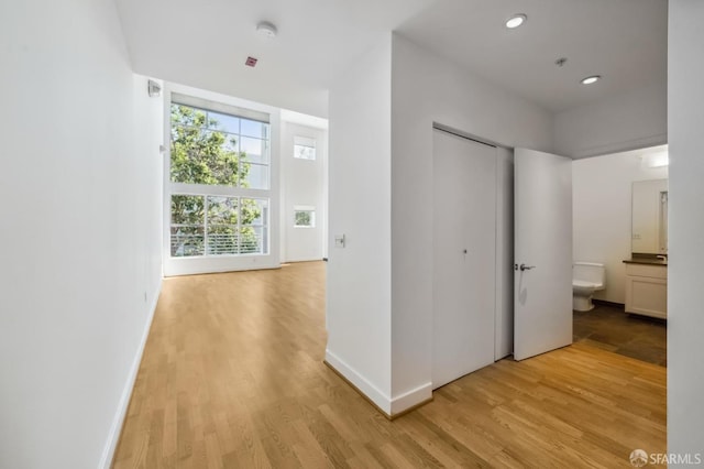 hall with light wood-type flooring