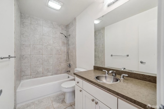 full bathroom featuring tile patterned floors, tiled shower / bath, vanity, and toilet