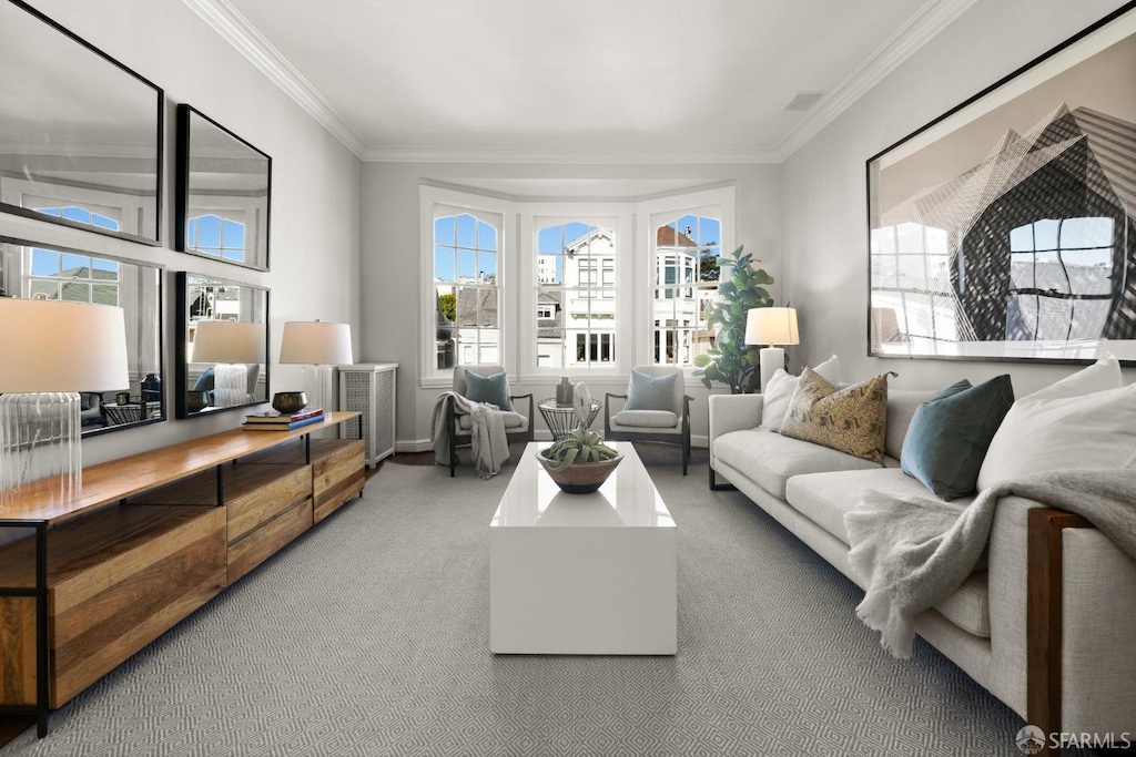 living room featuring plenty of natural light, ornamental molding, and carpet flooring