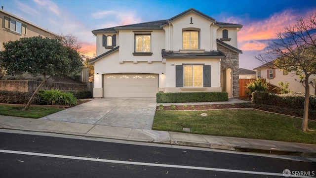 view of front facade featuring a lawn and a garage