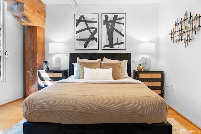 bedroom featuring baseboards and wood finished floors