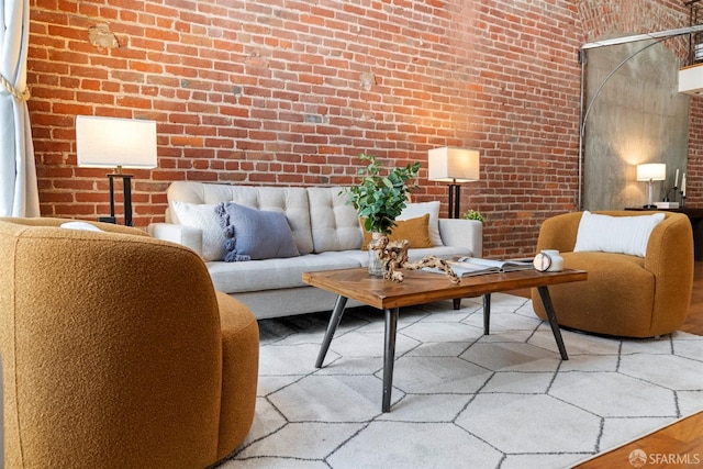 living area featuring brick wall