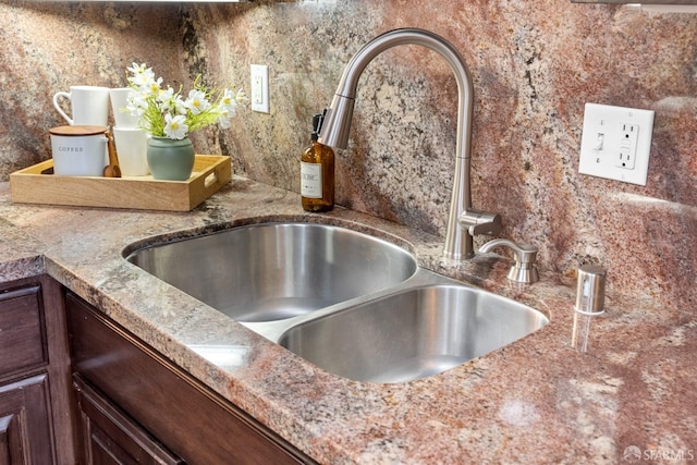 interior details featuring dark brown cabinetry and a sink