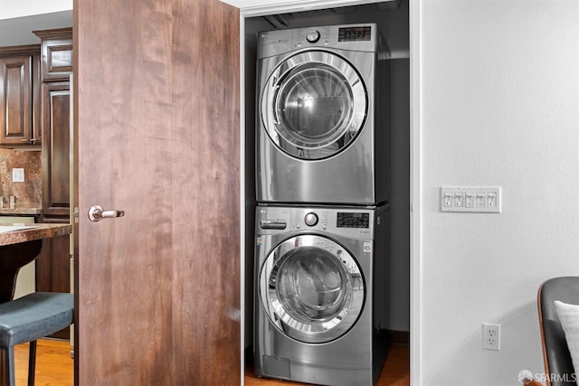 laundry room with laundry area and stacked washer / drying machine