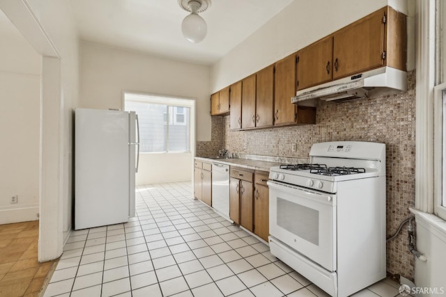 1385-1387 Vallejo St, San Francisco, CA 94109 - kitchen featuring white appliances, under cabinet range hood, light countertops, a sink, and backsplash