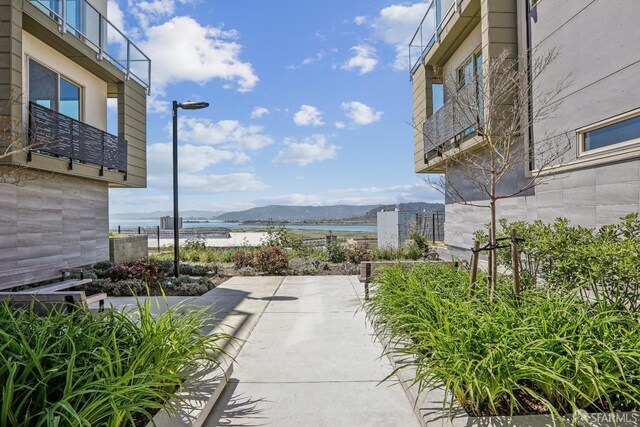 view of patio with a water and mountain view