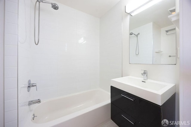 bathroom featuring vanity and tiled shower / bath