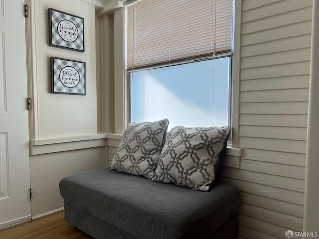 sitting room with baseboards and wood finished floors