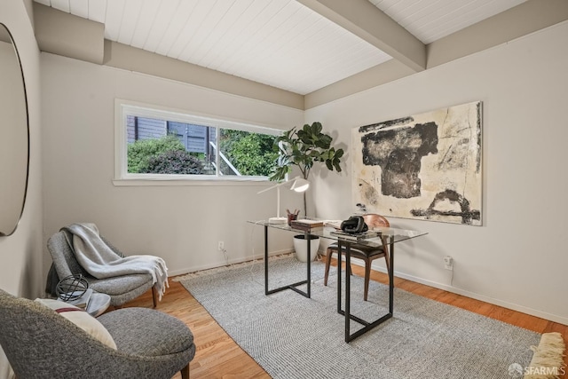 home office with beamed ceiling, baseboards, wood ceiling, and wood finished floors