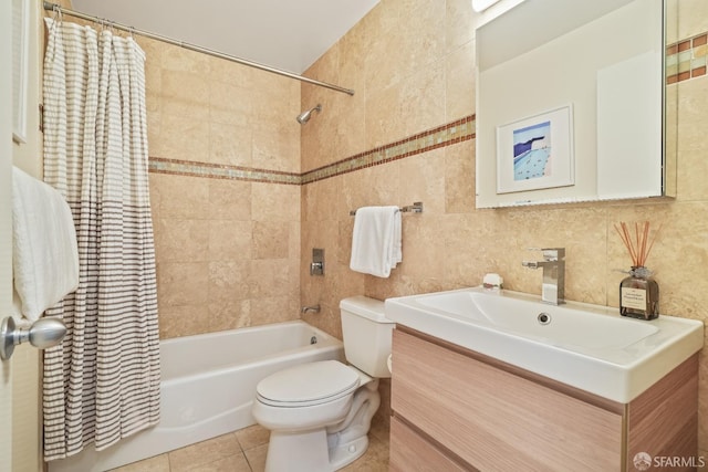 full bath featuring tile patterned floors, toilet, tile walls, shower / bath combination with curtain, and vanity